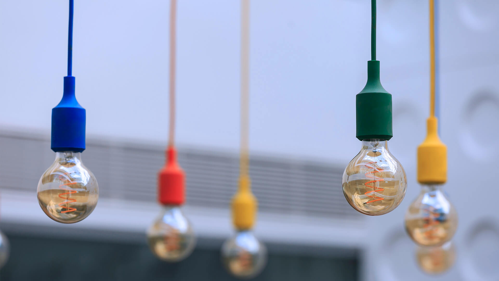 A detail shot of multicolored, hanging lightbulbs in the Grainstore building