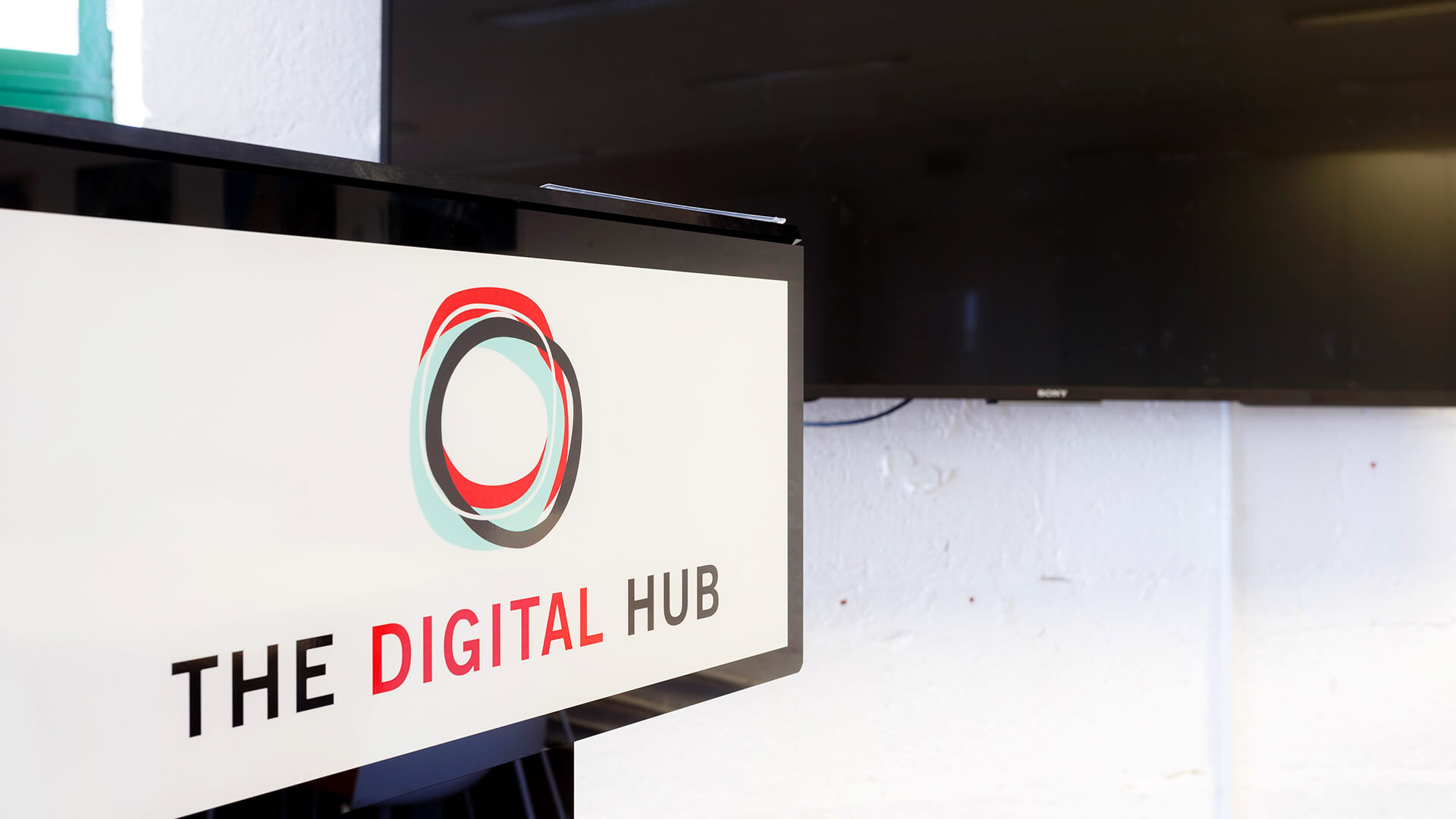 'The Digital Hub' logo displays on a screen in the Learning Studio