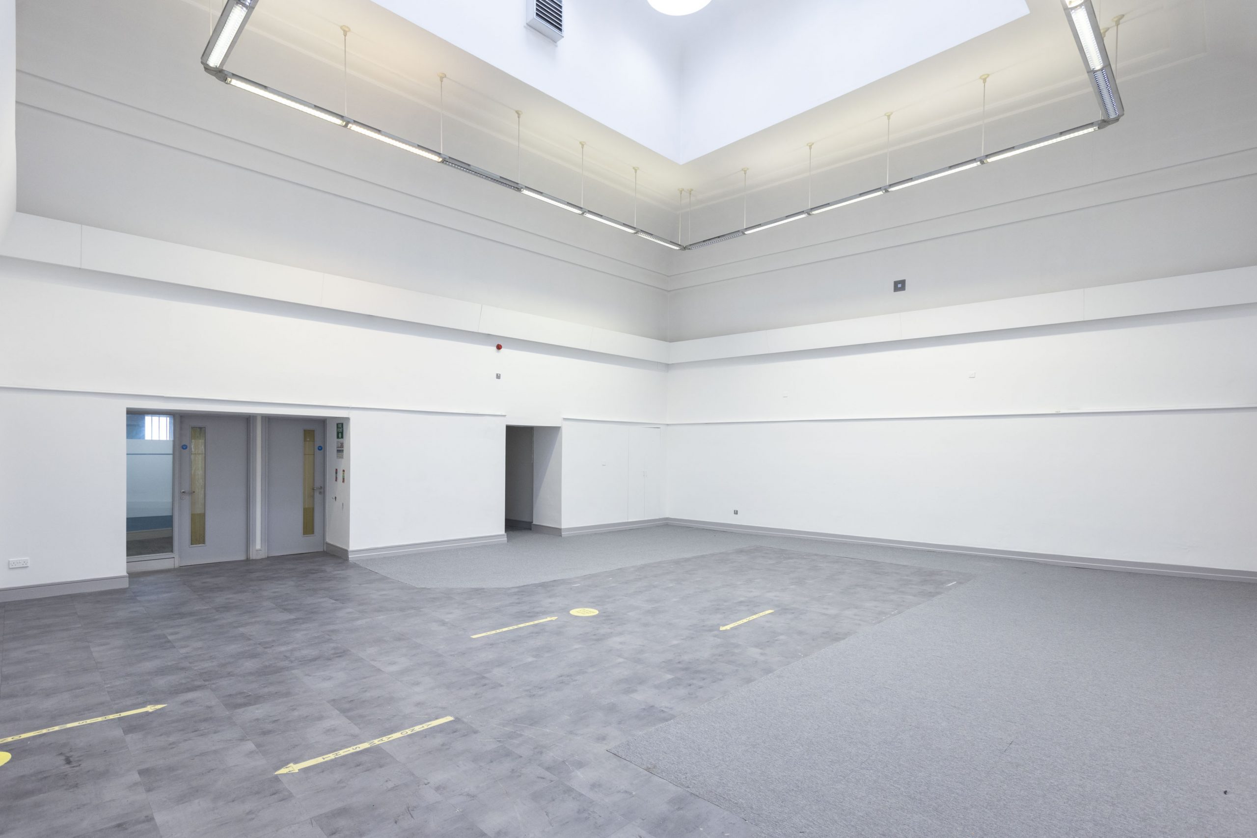 Picture of The Bank with grey floors and white walls, wide open space.