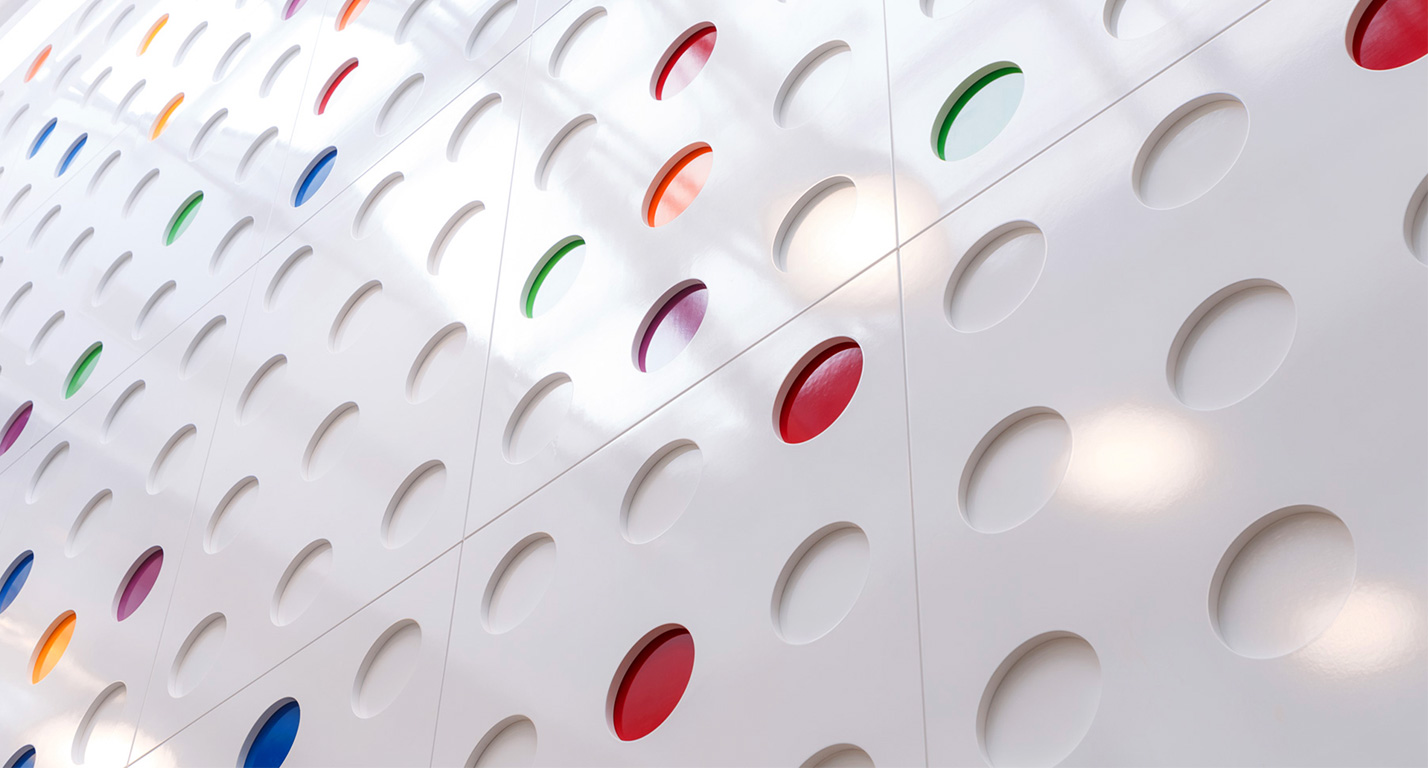A modern feature wall with bright dots of colour in the Grainstore building at The Digital Hub.